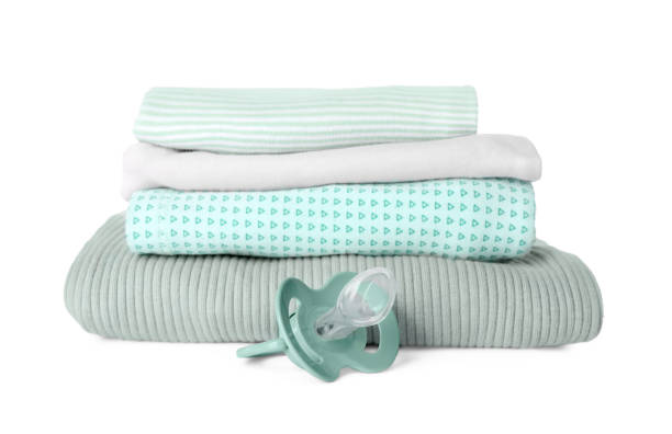 istock Stacked clothes and baby pacifier isolated on white 1769660492