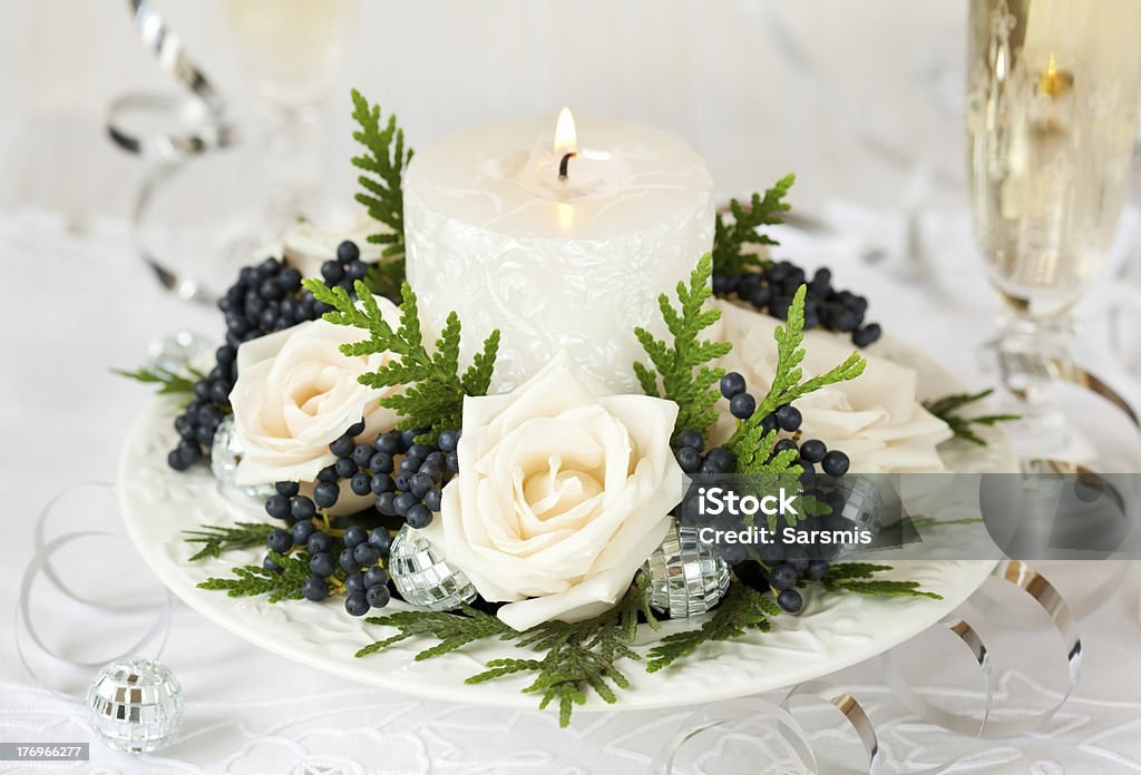 Christmas table decoration "Christmas table decoration with roses,winter berries and candle" Arrangement Stock Photo