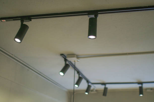 istock Illuminated black track light on ceiling. Modern LED Hanging rotating spot light. Pendant interior. 1769665896