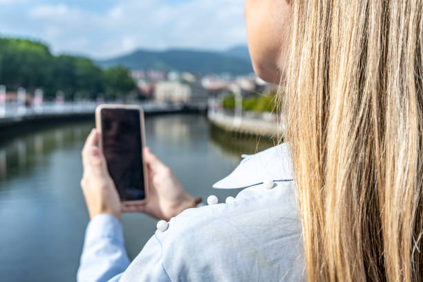 istock Unrecognizable young woman looking at her smart phone screen, blurred background 1769685045