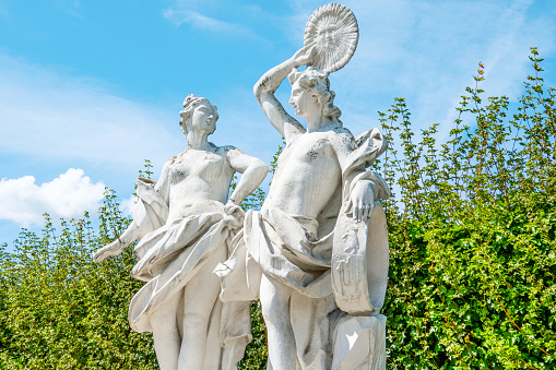 Vienna, Austria - August 8, 2023: Antique sculptures in the Belvedere Gardens at Belvedere Palace