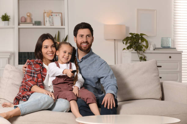 istock Happy family watching TV on sofa at home, space for text 1769747561