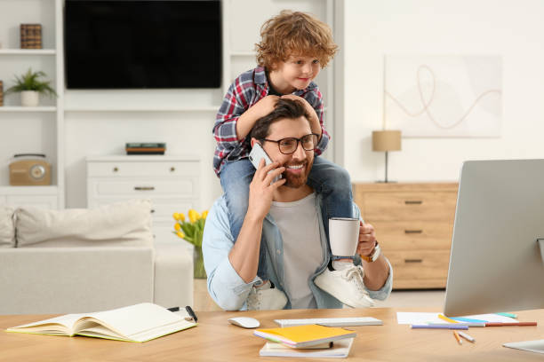 istock Man working remotely at home. Father with his child at desk 1769758119