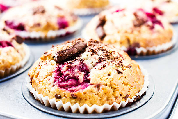 istock Festive chocolate small cakes with cherry  in baking tray. Close 176976335
