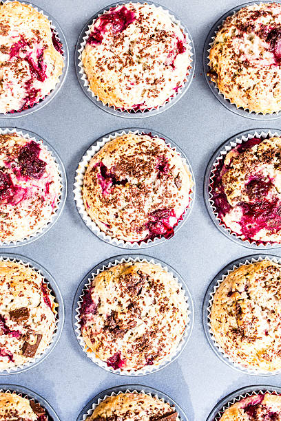 istock Homemade chocolate muffins with cherry  in baking tin  top view. 176976346