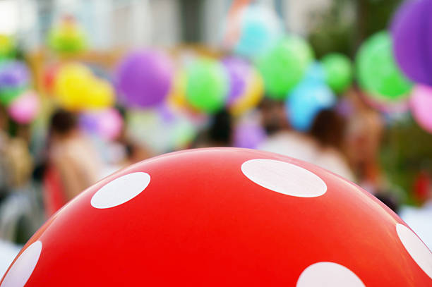 Brother and sister with colorful balloons in the park