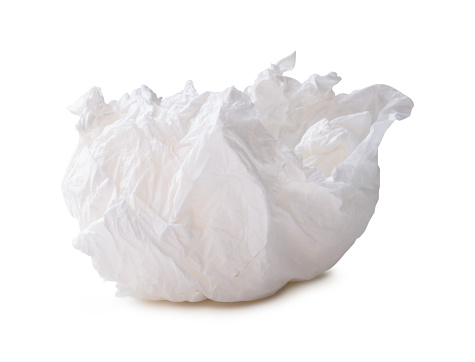 Single white screwed or crumpled tissue paper or napkin in strange shape after use in toilet or restroom is isolated on white background with clipping path.