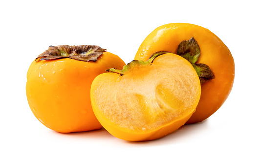 Orange ripe persimmons with half in stack are isolated on white background with clipping path.