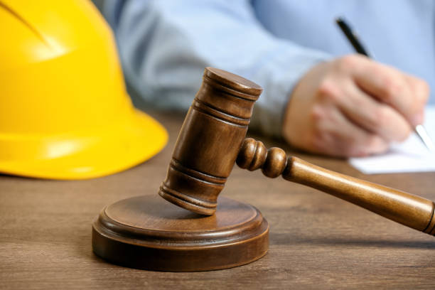 istock Construction and land law concepts. Man writing at wooden table, focus on gavel 1769779937