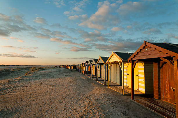 Wooden beach hut at sunset Beach hut at sunset in West Wittering Beach chichester stock pictures, royalty-free photos & images