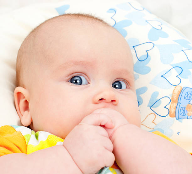 istock Infant with hands in mouth 176978981