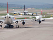 Three passenger aircrafts in heavy traffic on the ground