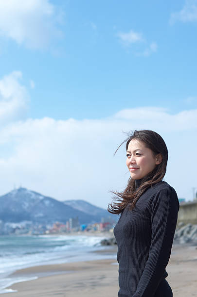 istock Woman on the windy beach 176979337