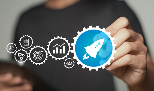 Startup business concept. Man touching a rocket icon button symbolizes the quick start of a business. Business financial growth analysis technology.