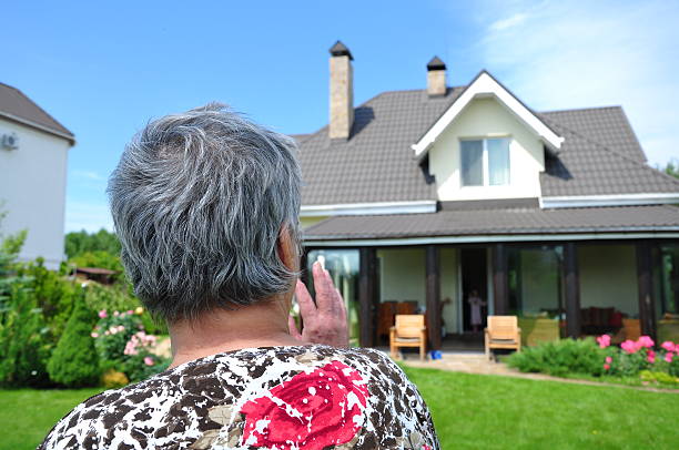 woman looking to a house