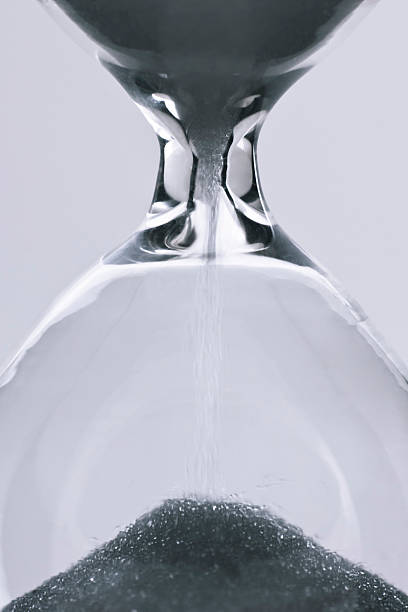 istock Macro shot of a clear hourglass with dark sand 176980912