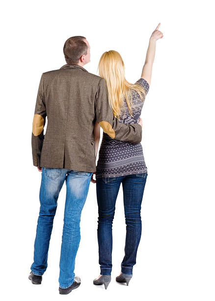 istock Back view of young couple pointing at wall. 176981274