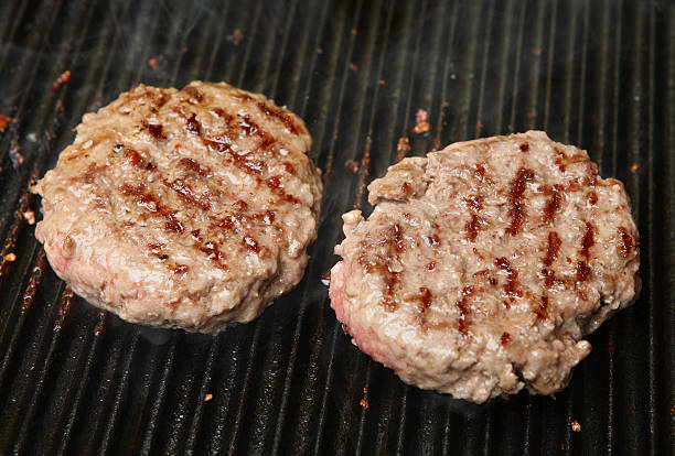 istock Beef Burgers Cooking on Griddle Plate 176981595