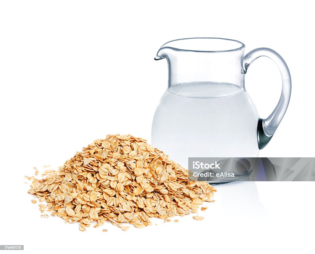 Cereal flakes and fresh water Cereal flakes and glass jug with fresh water on white background Breakfast Stock Photo