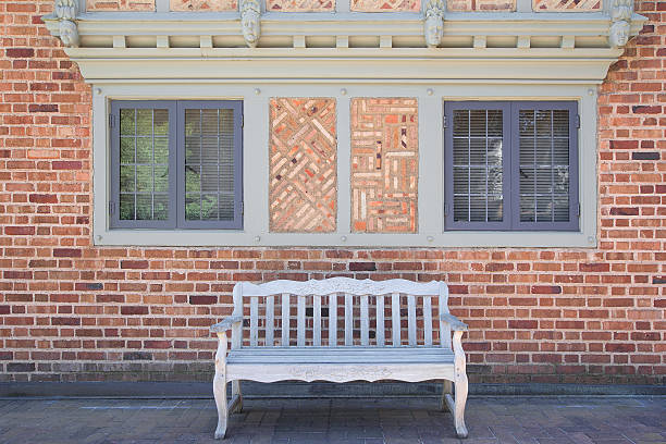 istock House Brick Exterior with Wood Bench 176982831
