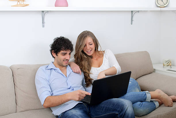 istock Young couple watching something on a laptop 176982865