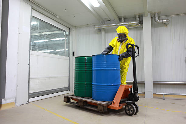 istock professional working with barrels of chemicals on forklift 176983645