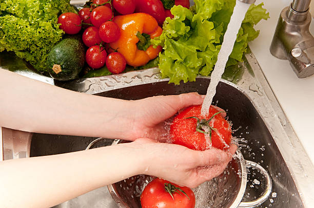 istock Woman washing tomatoes in the sink 176984331
