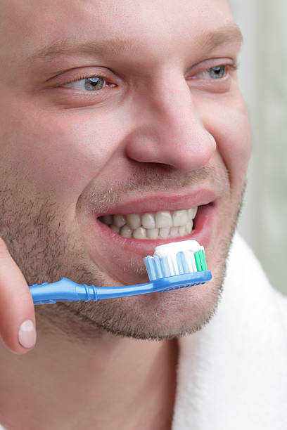 istock young beauty man with toothbrush 176984424