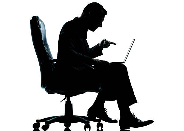 istock one business man computer computing sitting in armchair silhouette 176984483