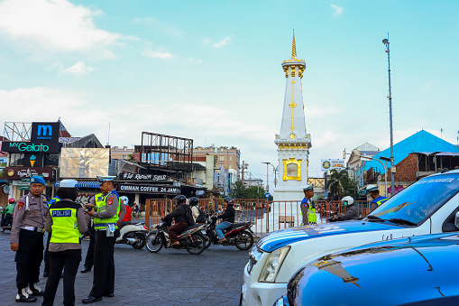 Yogyakarta, Indonesia, October 2, 2023 : The Indonesian policeman are on duty to manage the traffic around Tugu Jogja