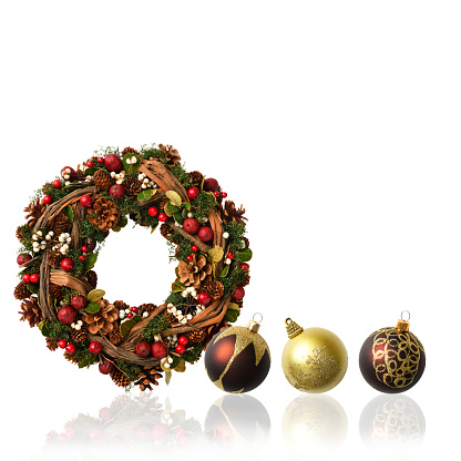 Close-up of Christmas Wreath with Christmas ornament on white background.