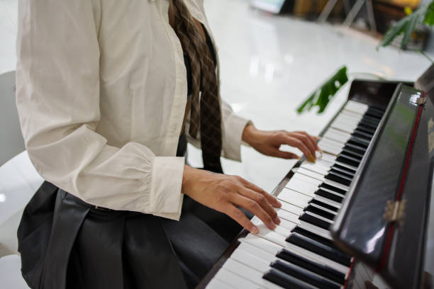 Close-up of hands playing piano