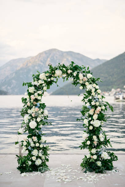 istock Wedding arch stands on a pier strewn with flower petals 1769852885