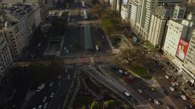 A drone flies over the top of the obelisk in Buenos Aires, view of the central avenue
