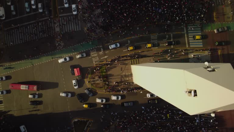 Traffic near the obelisk in Buenos Aires, crowds of people, top view