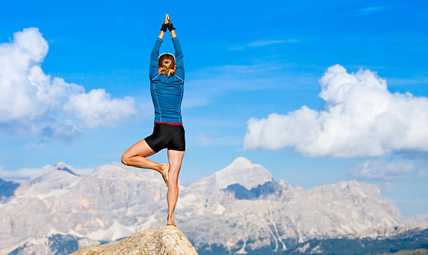 istock Woman doing yoga on rock 176985735