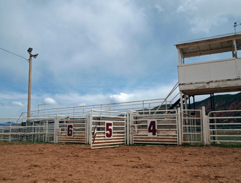 An open gate at a small rural rodeo arena.