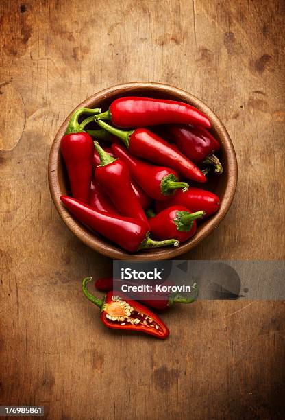 Red Chili Peppers In Wooden Bowl On Wooden Table Stock Photo - Download Image Now - Bowl, Cayenne Pepper, Chili Pepper