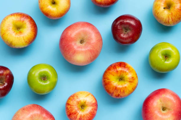 istock Variety of fresh apples on blue background. 1769859728