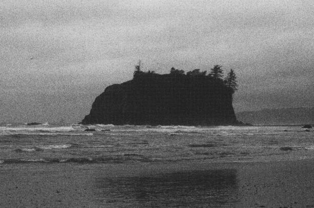 istock Beach on a cloudy day with large rock formation 1769860288