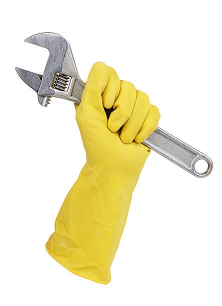 istock Gloved hand holding a wrench 176986646