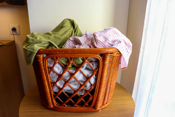 istock Rattan laundry basket with full of clothes. Household chore concept 1769868942