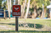 Signpost with warning about drone usage prohibition in state park. Warning notice against using UAV and quadcopters