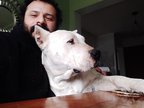 Man taking selfie with large white dog