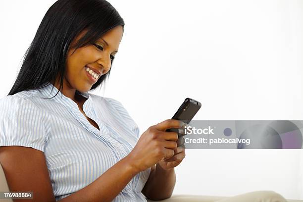 Charming Young Woman Using A Mobile Phone Stock Photo - Download Image Now - Adult, Adults Only, African Ethnicity
