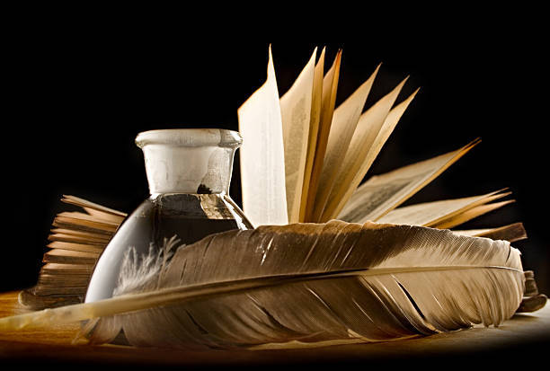 istock Feather with the bottle full of ink and a book 176989071