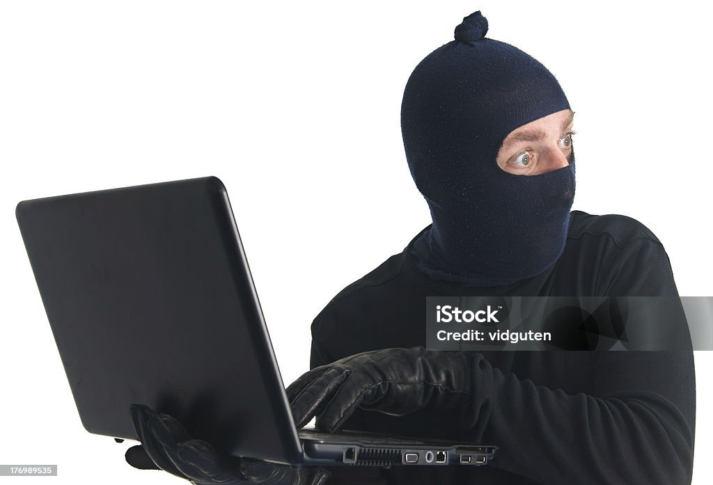 Испуганный robber с компьютер, изолированные на белом - Стоковые фото Взломщик роялти-фри