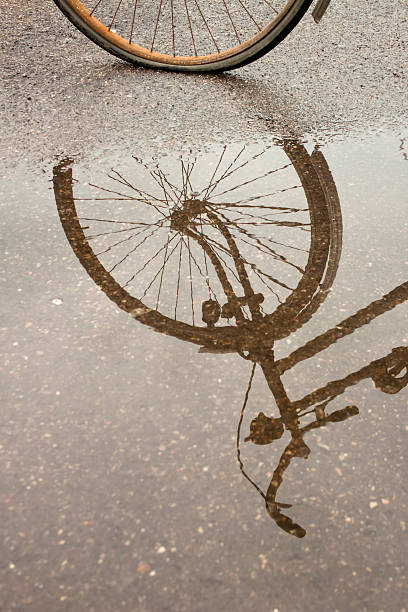 istock Bicycle reflection in a puddle of water 176990106