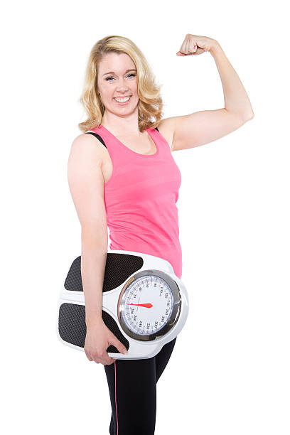 istock Smiling adult female holding scale 176990460