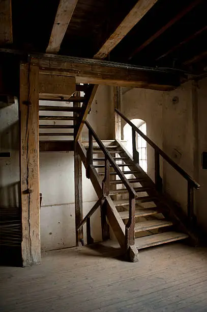 OldA building's interior with woodenA stairs. (vertical)